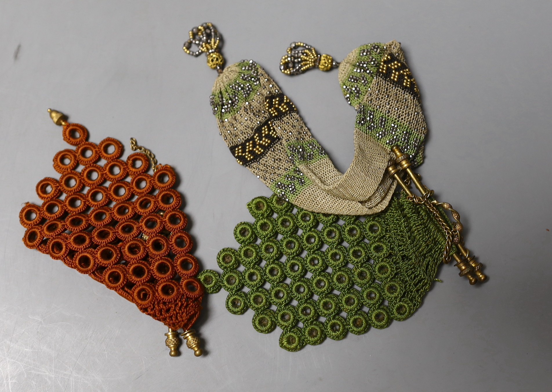 A late 19th century embroidered bible bag another smaller finely knitted bible bag, eight hand worked purses, a floral knitted purse, three misers purses and a novelty “jug” shaped purse,(15)